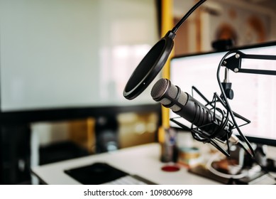 Close-up image of microphone in podcast studio. - Shutterstock ID 1098006998