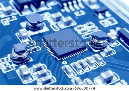 Closeup image of microprocessor on electronic circuit board. Blurred and toned image. Shallow DOF.
