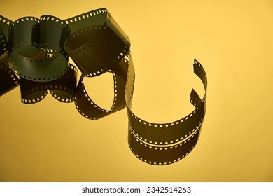 A close-up image of a motion picture film reel casting a reflection in the light - Powered by Shutterstock