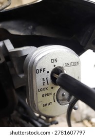Close-up image of a motorcycle ignition switch with the key in the OFF position