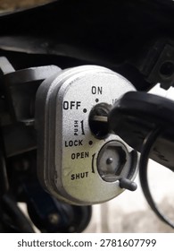 Close-up image of a motorcycle ignition switch with the key in the OFF position