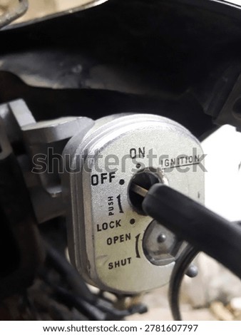 Close-up image of a motorcycle ignition switch with the key in the OFF position