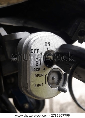 Close-up image of a motorcycle ignition switch with the key in the OFF position