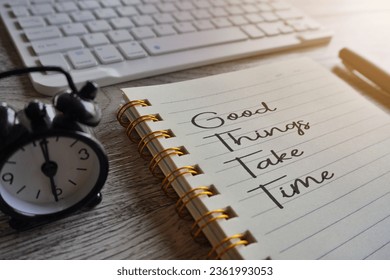 Closeup image of notebook with text GOOD THINGS TAKE TIME, clock and pen on table. Motivation concept - Powered by Shutterstock