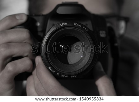 Close-up image of a photographer taking a picture