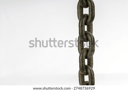 A close-up image of a rusty chain link, hanging against a plain white background. The image showcases the texture and detail of the metal, emphasizing the strength and durability of the chain.