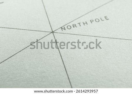 Close-up image of a section from an Antarctic map, featuring the North Pole label and grid lines for latitude and longitude The terrain is depicted using shading or contour lines