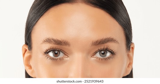 A close-up image showcasing the beautiful grey eyes of a woman with natural makeup. Ideal for beauty, skincare, or eye care concepts, this high-quality photo emphasizes elegance and allure.