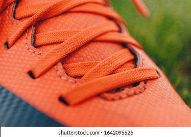 Close-up Image Of Sports Cleats. Red Sports Cleats U Designed For Field Sports Such As Soccer, Football, And Baseball