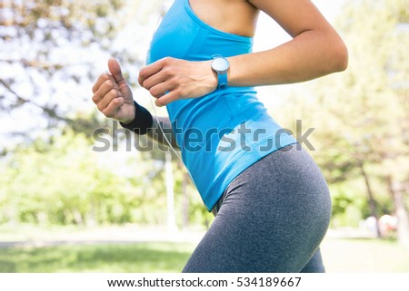 Closeup image of a sporty female body outdoors