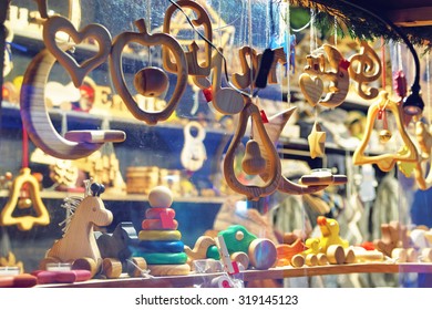Close-up image of a stand with wooden toys and Christmas tree decorations at the Christmas Market in Old Riga, Latvia