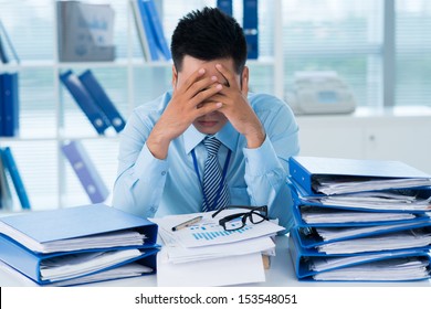 Close-up image of a stressful businessman tired from his work on the foreground 