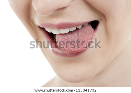 Close-up image of a teasing woman with tongue out against the white background