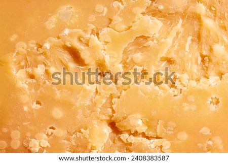 Close-up image, texture of hard cheese, delicious Parmesan. Traditional taste of Italian cheese. Concept of food, taste, art of organic products, healthy, natural food.