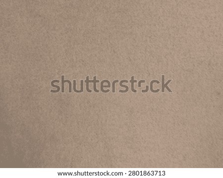 Close-up image of a textured beige surface, possibly sand or fine granular material.
