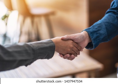 Closeup image of two people shaking hands 