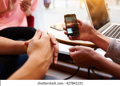 Closeup Image Of Two Person Are Watching Video In Internet Via Cellphone, While They Are Sitting In Hipster Coffee Shop Interior. Closely Of Woman`s Hand Is Holding Mobile Phone With Copy Space Screen