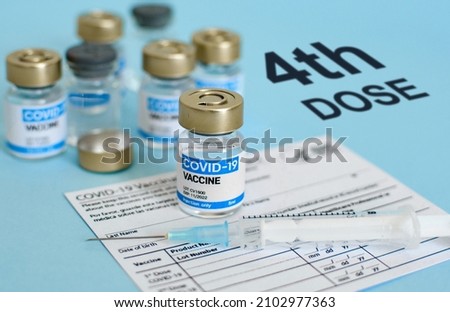 Close-up image of vaccine vial and syringe on CDC covid-19 vaccination record card  Fourth or 4th dose text on blue background 