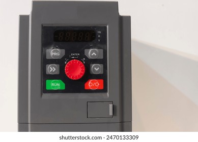 Close-up image of a variable speed drive control panel featuring control buttons and a display screen.