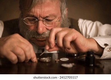 Closeup image of a Victorian watchmaker working on an antique pocket watch - Powered by Shutterstock