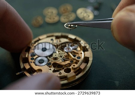 Closeup image of a watchmaker working on an antique pocket watch