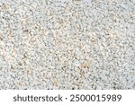 A close-up image of white gravel stones, ideal for backgrounds, textures, and construction-related themes.