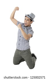 Close-up Image Of A Winner Male Teenager Kneeling On The Floor