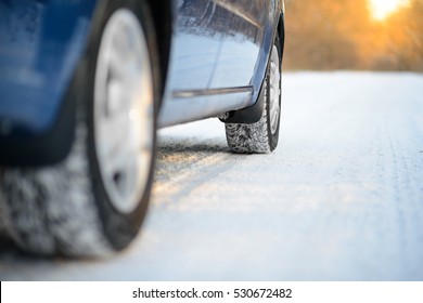 Close-up Image Of Winter Car Tire On The Snowy Road. Drive Safe Concept.