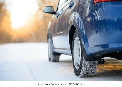 Close-up Image Of Winter Car Tire On The Snowy Road. Drive Safe Concept.