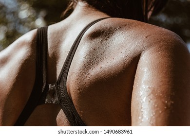 Close-up image of woman back with water drops