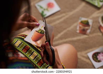 Closeup Image Of Woman Cutting Out Picture Of Cactus When Making Wish Map