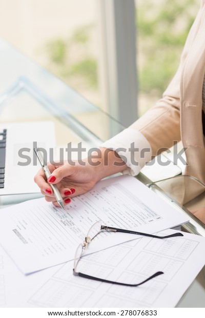 Close-up image of woman filling car\
accident questionnaire