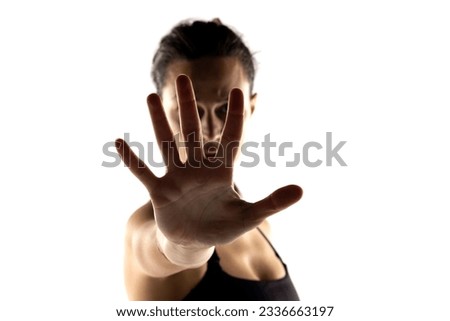 Similar – Close up front portrait of one young middle age athletic woman in sportswear in gym over dark background, standing in boxing stance with hands and fists, looking at camera