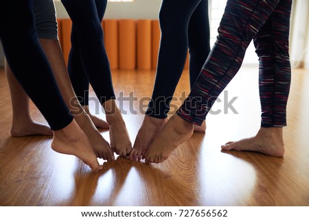 Close-up image of women pointing toes together