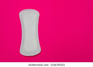 Close-up image of a women's sanitary napkin on a pink background leaving copy space. Concept of intimate hygiene of the woman when she is with the period.