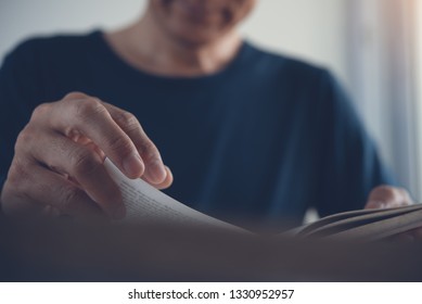 Closeup Image Of Young Asian Man Reading A Book. Casual Man, Student Opening And Relaxed Reading Book In University Library, Vintage Style.