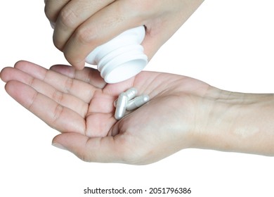 Close-up Image Of A Young Asian Man Holding A Pill And She Is Taking A Headache Medicine Or Taking A Tonic. Concept Of Healthcare And Medicine