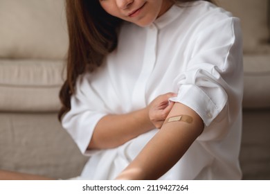 Closeup Image Of A Young Woman With Adhesive Bandage, Medical Plaster, Band Aid On Her Arm