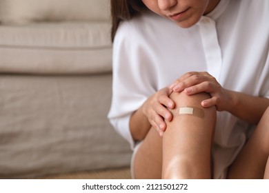 Closeup Image Of A Young Woman With Adhesive Bandage, Medical Plaster, Band Aid On Her Knee