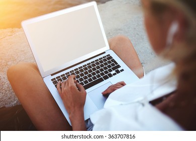 Closeup Image Of Young Woman Watching Video On Laptop Computer With Blank Copy Space Screen For Your Text Message Or Information, Female Teenager Holding Open Net-book On Knees While Sitting Outside