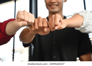 Close-up images of People of different ages, genders bumping their fists on each other, symbolizing their unity and support. - Powered by Shutterstock