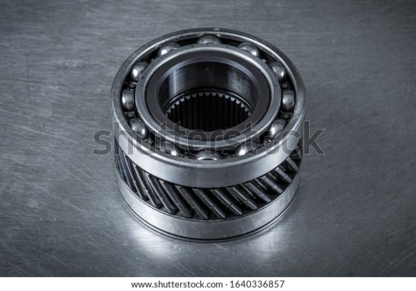 Close-up of an\
important spare part of a car gearbox. Glossy metal bearing for\
car.  Metal  autotechnology\
background