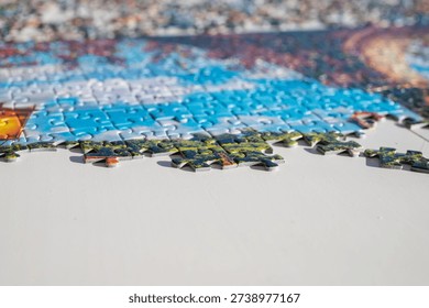 Close-up of incomplete jigsaw puzzle with missing pieces on table, shallow depth of field, problem solving and challenge concept.