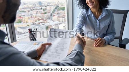 Similar – Image, Stock Photo Two young men shake hands. Close up of the hands in front of a green background.