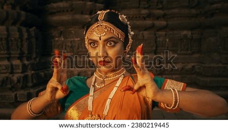 Close-Up of an Indian Female Dancer Displaying Symbolic Gesture with Expressive Face, Using Folkloric Dance to Tell a Story. Girl in Traditional Sari Showcasing the Art of Mudras Movement