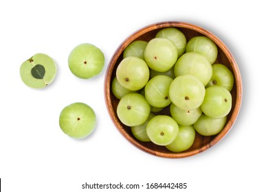 Closeup  Indian gooseberry fruits ( Amla, phyllanthus emblica ) with cut i n half slice in wooden bowl isolated on white background. Top view. Flat lay.
