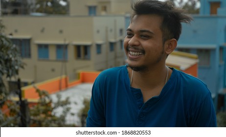 Closeup Of An Indian Young Man Posing Laughing Out Loud. Relax Profile Picture With A Confident Smile On The Face. Candid Of An Indian Boy Laughing