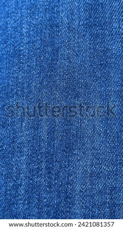 Close-up of indigo blue jean fabric texture, showcasing the detailed and rugged beauty of denim.