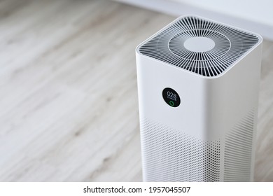 Closeup Of An Indoor Air Purifier In The Room Is Very Safe And Clean To Breathe While Dust Air Pollution Situation Outside Is Really Bad. Protect PM 2.5 Dust And Air Pollution Concept. Air Purifier.