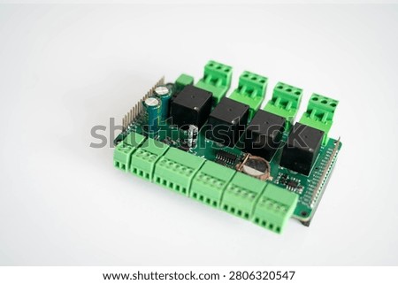Close-up of an industrial relay controller board isolated on a white background with copy space, representing IoT, embedded systems, industrial automation, smart control, electronics engineering and digital technology.
